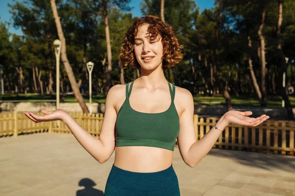 Young Redhead Woman Wearing Green Sports Bra Clueless Confused Open — Stock Photo, Image