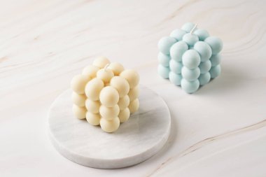 Bir beyaz kare baloncuk mum mermer bir tahta üzerinde ve bir mavi tropikal arka planda