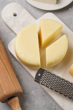 Mermer ve porselen tabaklarda çeşitli peynir türleri ve taze hamur. Geleneksel Gürcü açık turta khachapuri malzemeleri.