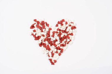 Beyaz yüzeyde pişirmek için kırmızı ve beyaz kalp şeklinde dekorasyon