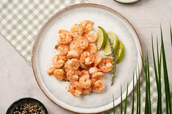Limon, sarımsak ve taze otlarla servis edilen ızgara karides veya kaplan karidesleri. Beton yüzeyde Scandi yuvarlak tabağında. Peskataryan protein besin değeri
