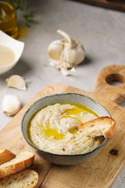 Geleneksel Arap mutfağı baba ganoush kızartması, kızarmış patlıcan, tahin, kişniş, sarımsak, zeytin yağı, limon suyu, kızarmış baget ekmek, ahşap tahta.