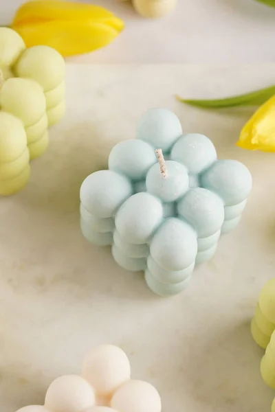 Many Bubble Candles White Beige Colored Blue Marble Board Spring — стоковое фото
