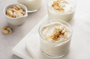 Kremalı yoğurtlu tatlı, krem peynir ve mermer tepside fıstık ezmesi.