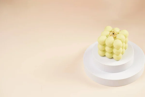 Pale Green Bubble Candle Two White Podiums Beige Colored Background — Stockfoto