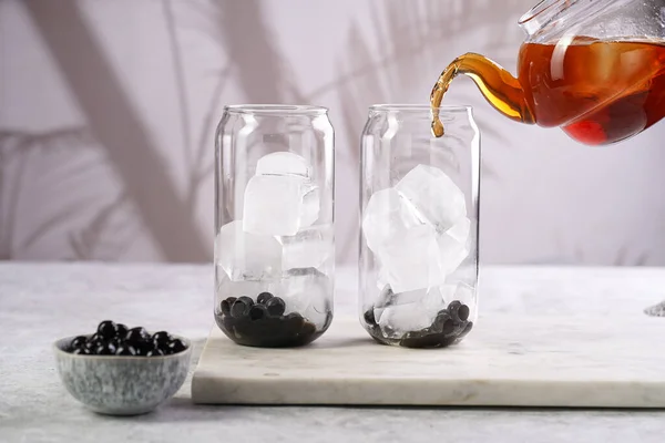 Female Hand Pouring Black Tea Transparent Glass Ice Cubes Cooked — Stock Fotó