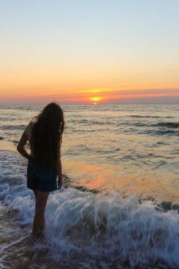 teenage girl on the sea beach, sunset, black sea, Ukrain
