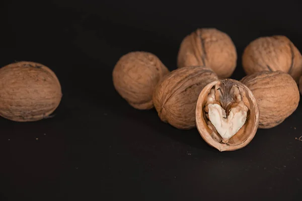 Walnut Green Yellow Leaves Background Close Chopped Nuts Lie Black — Stock Photo, Image