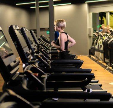 Simülatör atletizm antrenmanı aktivitesi, atlet spor kıyafetleri, atletik koşu gibi sağlıklı kadınlardan. İnce dinlenme bacakları, ağırlık