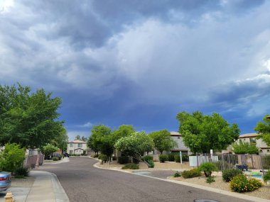 Dark blue summer monsoon sky above residential housing community in city of Phoenix, AZ