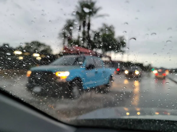 Obscured fuzzy and blurry view from driver seat during heavy monsoon rain in city of Phoenix, Arizona