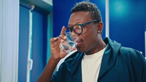 Happy black guy eating breakfast at home — Stock Video