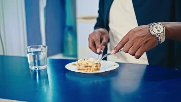 Happy black guy eating breakfast at home — Stock Video