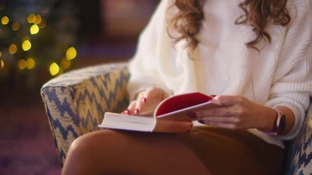 Mujer joven y feliz leyendo un libro mientras está sentada en un café. tiempo maravilloso en la cafetería. — Vídeo de stock