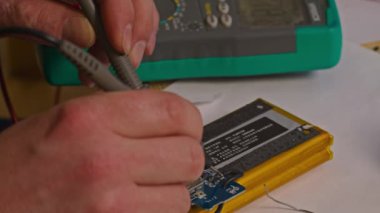 Kryvyi Rih, Ukrayna - Rusya 'nın Ukrayna' ya karşı 2022 yılındaki savaşı. Elektrik bankalarının yetersizliğinden dolayı elektrikçi Ukrayna Silahlı Kuvvetleri için ev yapımı şarj aletleri ve elektrik bankalarını lehimliyordu.