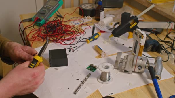 Kryvyi Rih, Ukraine - FEBRUARY 2022 war of Russia against Ukraine. due to the lack of power banks, the guy electrician was soldering home-made chargers and power banks for the Armed Forces of Ukraine — Stock Video