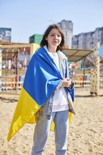 Портрет радостной украинки с ребенком и украинским флагом. Девушка ждет своего мужа с войны. Война между Россией и Украиной. — стоковое фото