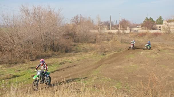 Kryvyi Rih, Ukraine - October, 24, 2021 Shot of the professional motocross rider on his motorcycle on the extreme terrain track. Biker flying on a motocross motorcycle. Construction background and sky — 비디오