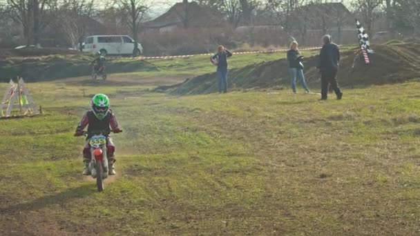 Kryvyi Rih, Ukraine - October, 24, 2021 Shot of the professional motocross rider on his motorcycle on the extreme terrain track. Biker flying on a motocross motorcycle. Construction background and sky — 비디오