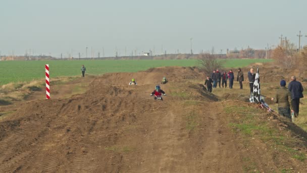 Kryvyi Rih, Ukraine - October, 24, 2021 Shot of the professional motocross rider on his motorcycle on the extreme terrain track. Biker flying on a motocross motorcycle. Construction background and sky — 비디오