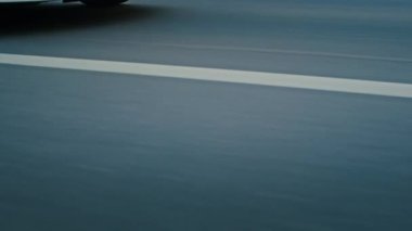 Krivoy Rog, Ukraine - 05.07.2022: Rolling shot of a BMW 3 series, German car, luxury sports sedan driving on a highway at sunset, close-up view