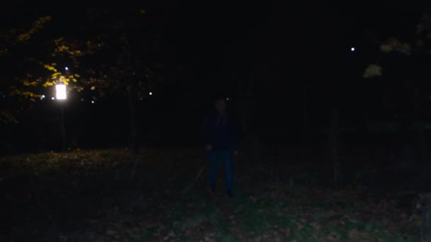 Cinematic shot, a man walks through a dark forest, a creepy zombie woman runs out of the darkness and attacks. horror. halloween. real evil. — Wideo stockowe