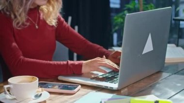 happy young woman sits with phone and computer at the table. business time. rest and work.