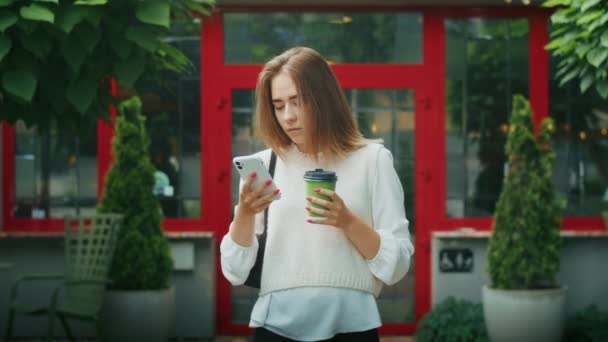 Joyful Girl Drinks Tea Street Rainy Weather Speaks Phone — Vídeo de stock