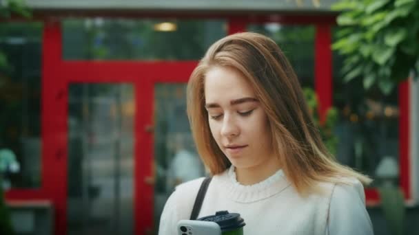 Joyful Girl Drinks Tea Street Rainy Weather Speaks Phone — Vídeo de Stock