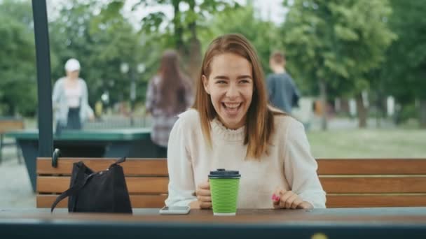 Joyful Girl Drinks Tea Street Rainy Weather Speaks Phone — Stockvideo