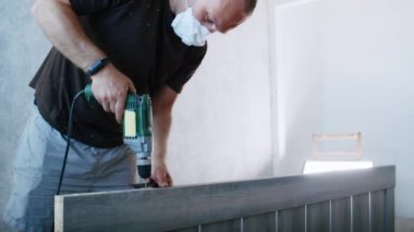 a professional male master is installing doors in an apartment