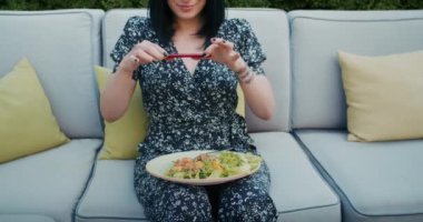 a happy woman photographs beautiful food in a restaurant, she is filled with joy