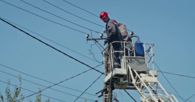 a team of male electricians perform work on the replacement of the cable.