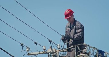 a team of male electricians perform work on the replacement of the cable.