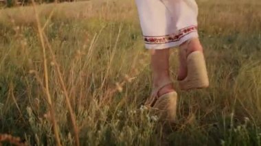happy young woman enjoying the sunset, wearing traditional ukrainian clothes. lifestyle in Ukraine