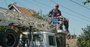 a team of male electricians perform work on the replacement of the cable.