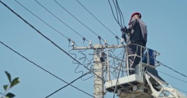 a team of male electricians perform work on the replacement of the cable.