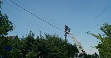 a team of male electricians perform work on the replacement of the cable.