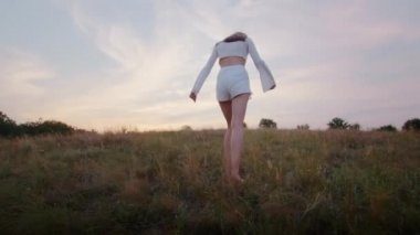 happy young woman enjoying the sunset, wearing traditional ukrainian clothes. lifestyle in Ukraine