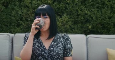 a european woman enjoys time in a restaurant, drinks coffee, eats food, she is overwhelmed with joy.