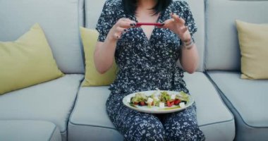 a happy woman photographs beautiful food in a restaurant, she is filled with joy