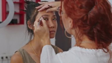 cosmetics and work as a stylist and makeup artist, women paint lips, eyes, face,