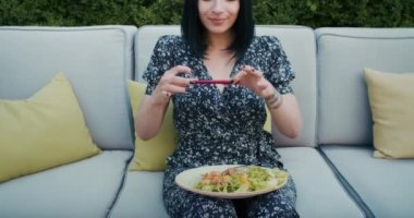 a happy woman photographs beautiful food in a restaurant, she is filled with joy