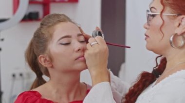 cosmetics and work as a stylist and makeup artist, women paint lips, eyes, face,