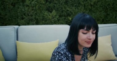a cheerful woman is fooling around in a restaurant, throws up french fries and tries to catch it with her mouth