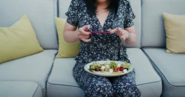 a happy woman photographs beautiful food in a restaurant, she is filled with joy