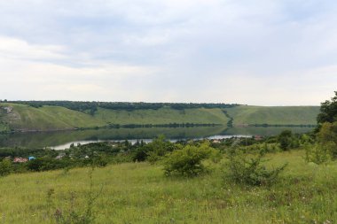 Landscape on the banks of a large river with calm smooth water. Bakota Bay view on the Dniester river, Ukraine.