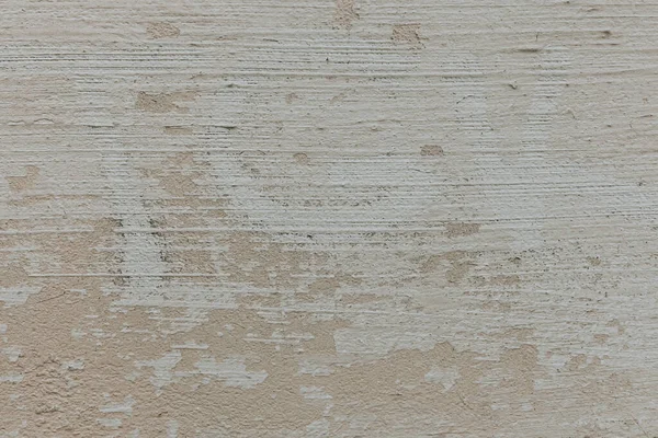 Fondo de pared de hormigón beige con textura detallada. Una superficie de yeso cepillado pintura con grietas y daños. —  Fotos de Stock