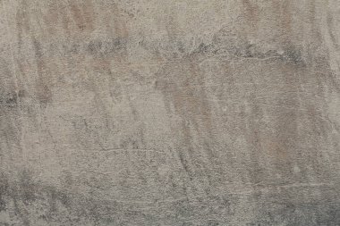 Bozuk desenli eskimiş beton duvar. Çatlaklar ve çizikler olan eski bir bej arka plan.