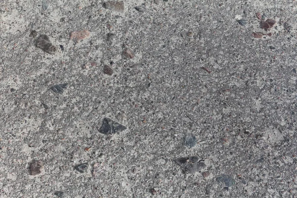 Antiguo camino de asfalto con piedras pequeñas de cerca. Fondo grunge gris con textura orgánica detallada. —  Fotos de Stock